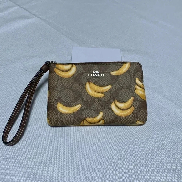 Coach Handbags - COACH Wristlet, Banana Print. NWT.